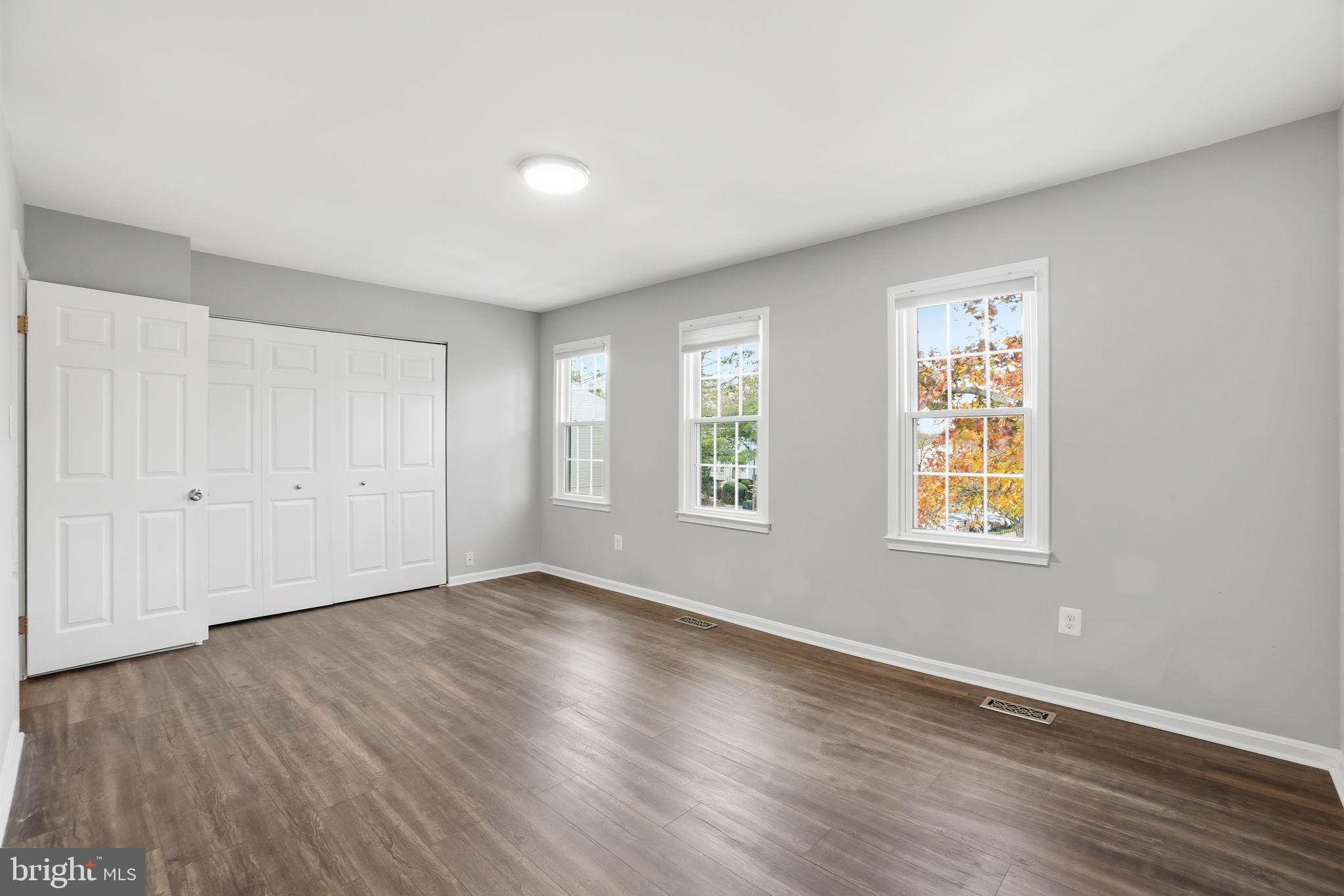 9175 Broken Oak Place, Unit 39B Burke, VA 22015 - Photo 25 of 35 an empty room with wooden floor and windows