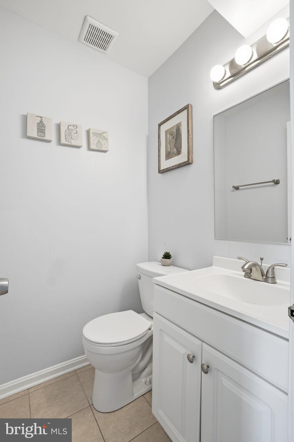 9175 Broken Oak Place, Unit 39B Burke, VA 22015 - Photo 27 of 35 a bathroom with a toilet a sink and mirror
