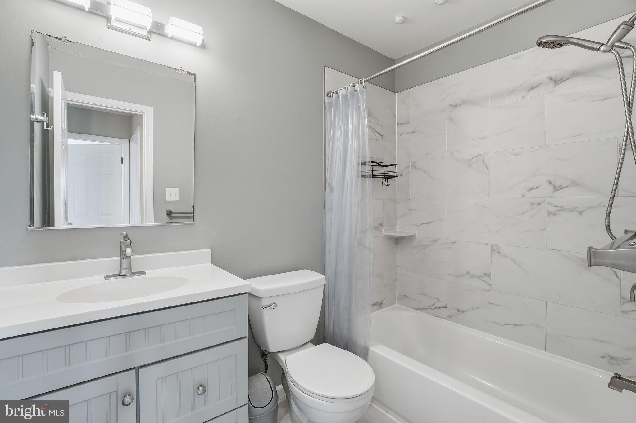 9175 Broken Oak Place, Unit 39B Burke, VA 22015 - Photo 28 of 35 a bathroom with a sink toilet and shower