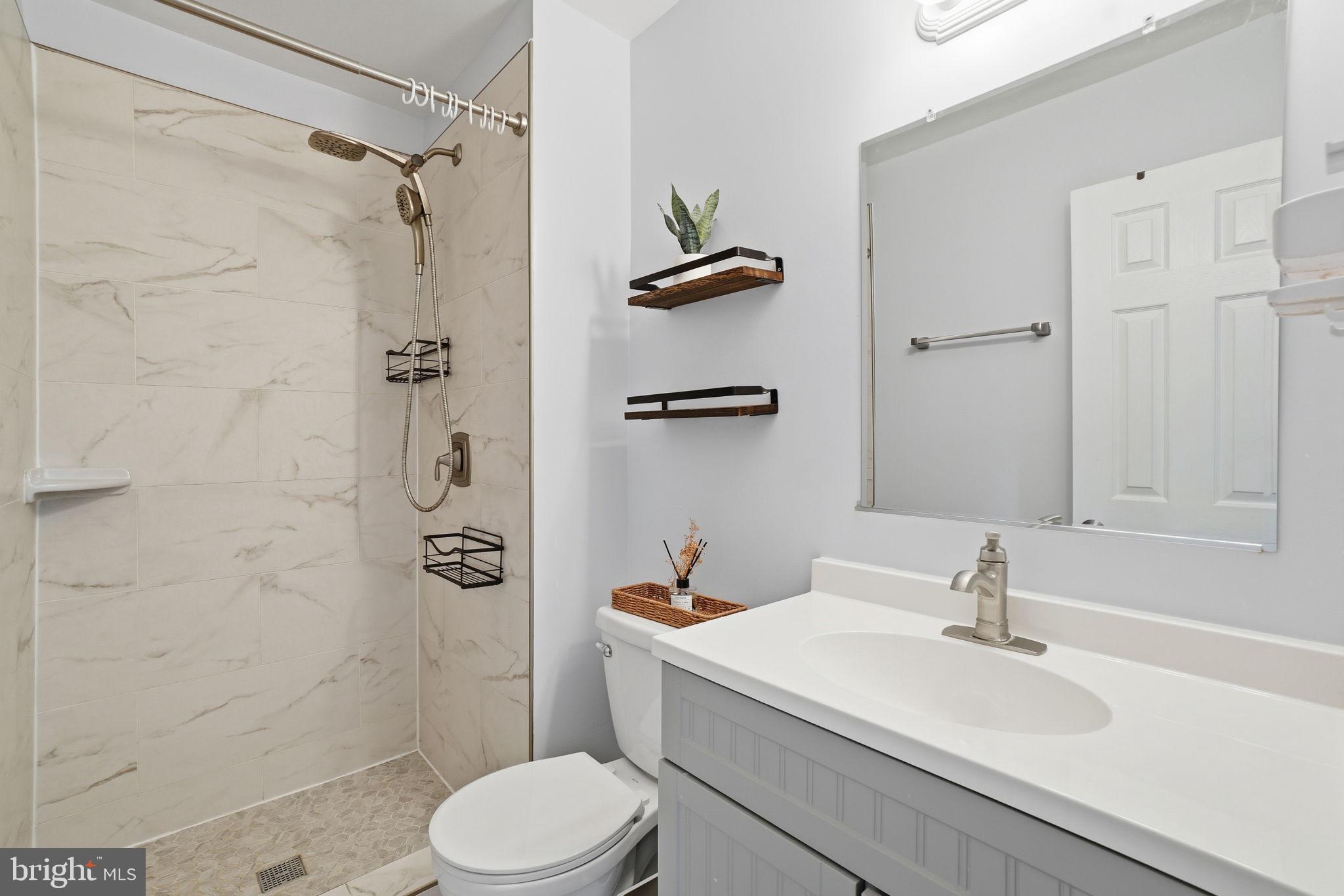 9175 Broken Oak Place, Unit 39B Burke, VA 22015 - Photo 30 of 35 a bathroom with a sink toilet and shower