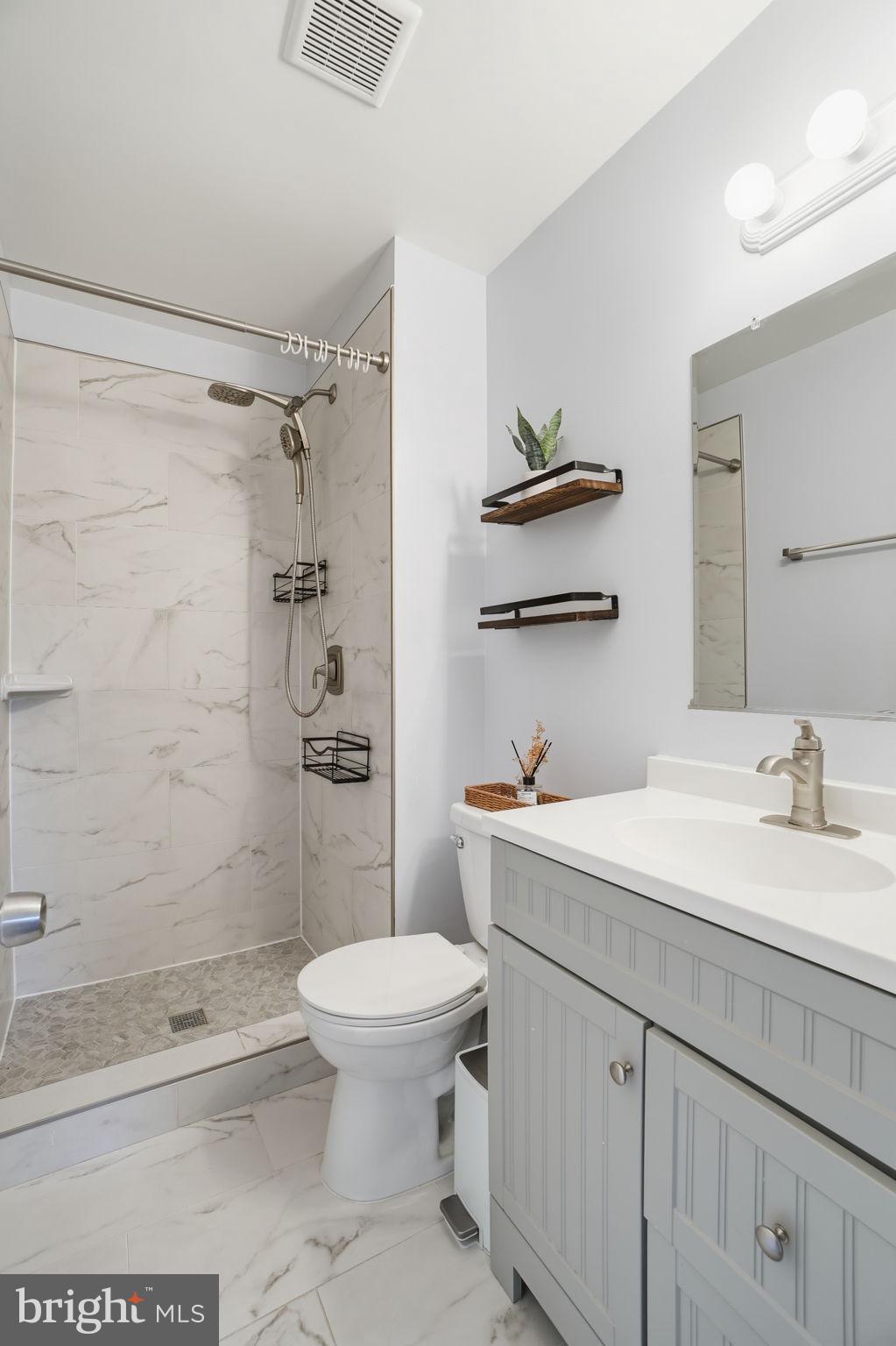 9175 Broken Oak Place, Unit 39B Burke, VA 22015 - Photo 31 of 35 a bathroom with a sink a toilet and shower