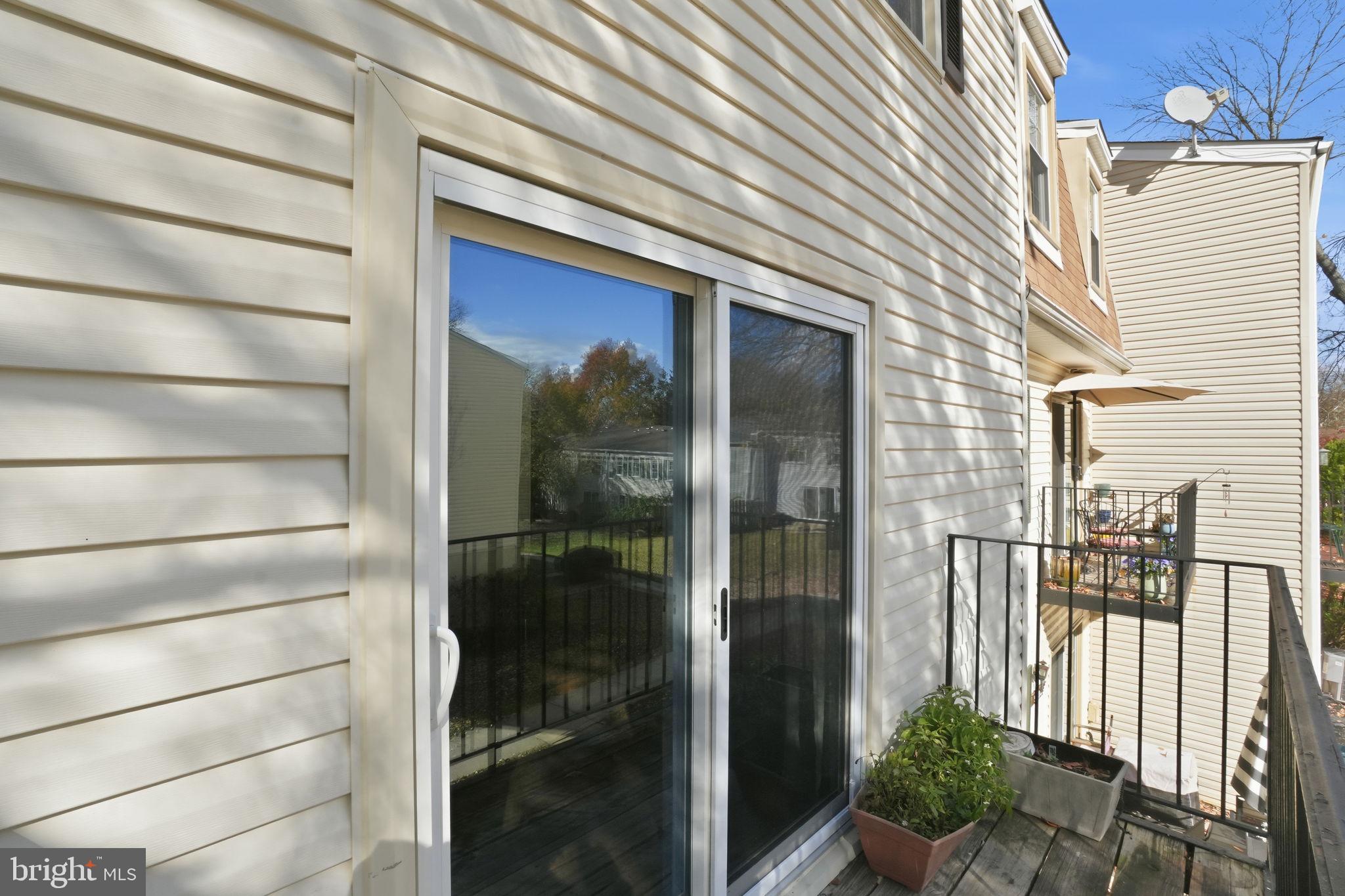 9175 Broken Oak Place, Unit 39B Burke, VA 22015 - Photo 34 of 35 a front view of a house with a glass door