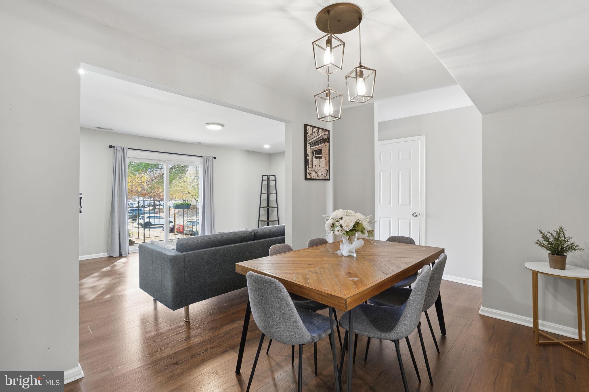 9175 Broken Oak Place, Unit 39B Burke, VA 22015 - Photo 9 of 35 a view of a dining room with furniture wooden floor and chandelier