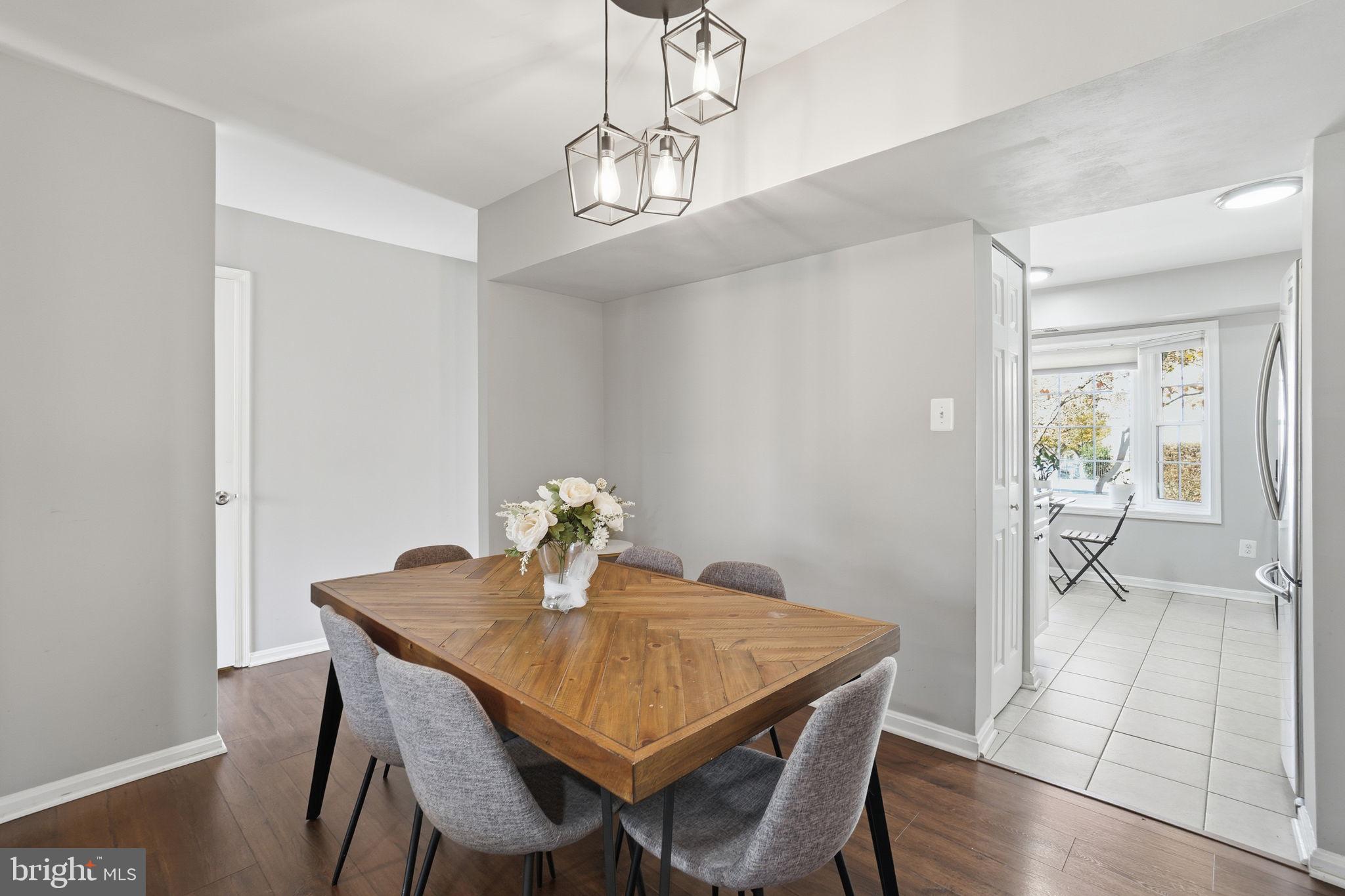 9175 Broken Oak Place, Unit 39B Burke, VA 22015 - Photo 10 of 35 a view of a dining room with furniture and a chandelier