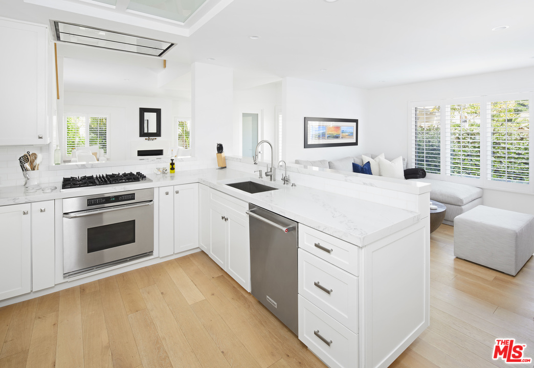 52 Olive Road Santa Barbara, CA 93108 - Photo 5 of 13 a kitchen with a stove a sink and a refrigerator