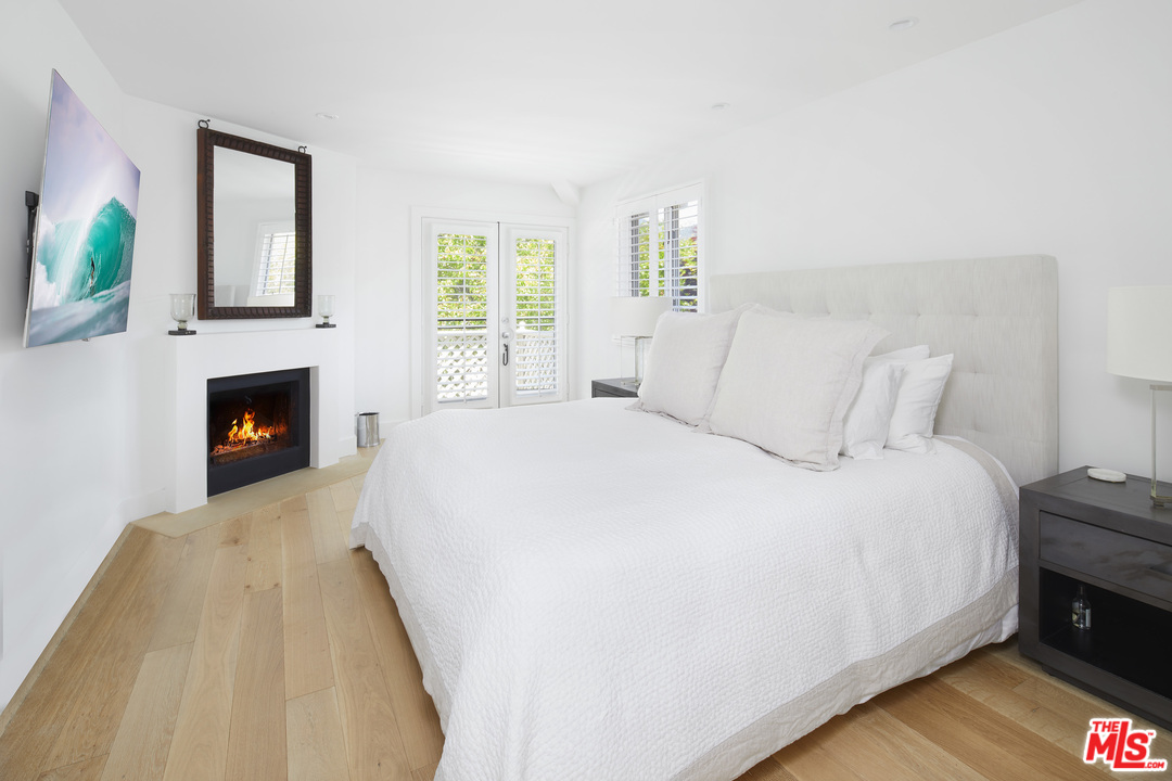 52 Olive Road Santa Barbara, CA 93108 - Photo 9 of 13 a bedroom with a bed and a fireplace