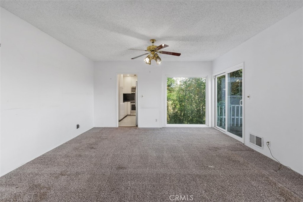 4121 Park View Terrace Riverside, CA 92501 - Photo 18 of 41 a view of a big room with windows and chandelier fan