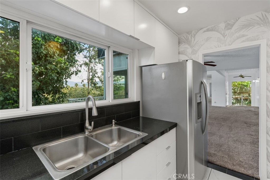 4121 Park View Terrace Riverside, CA 92501 - Photo 20 of 41 a kitchen with granite countertop a refrigerator and a sink