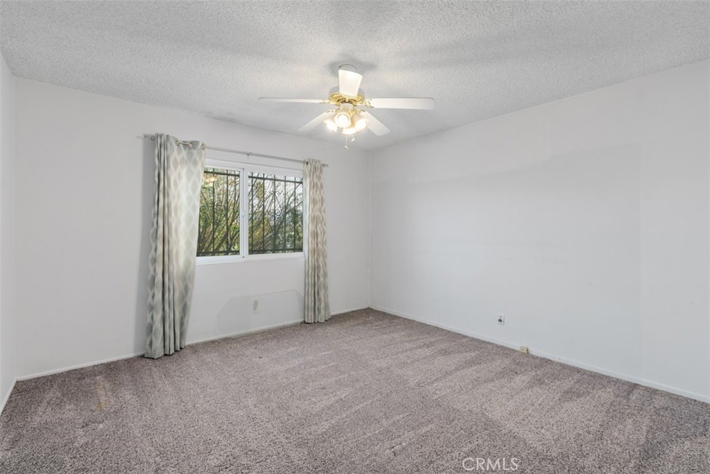 4121 Park View Terrace Riverside, CA 92501 - Photo 23 of 41 an empty room with a window and a fan