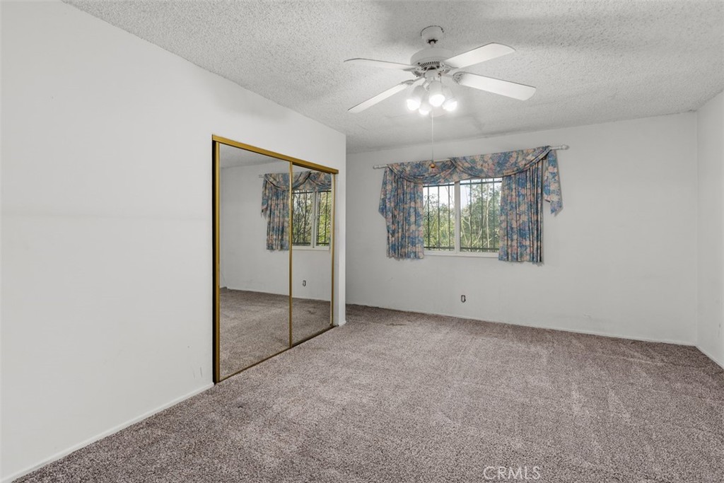 4121 Park View Terrace Riverside, CA 92501 - Photo 24 of 41 an empty room with fan and windows