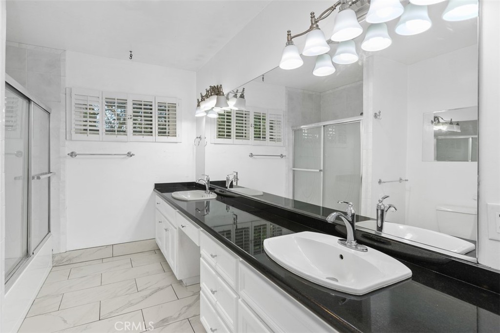 4121 Park View Terrace Riverside, CA 92501 - Photo 28 of 41 a bathroom with a granite countertop sink and a mirror