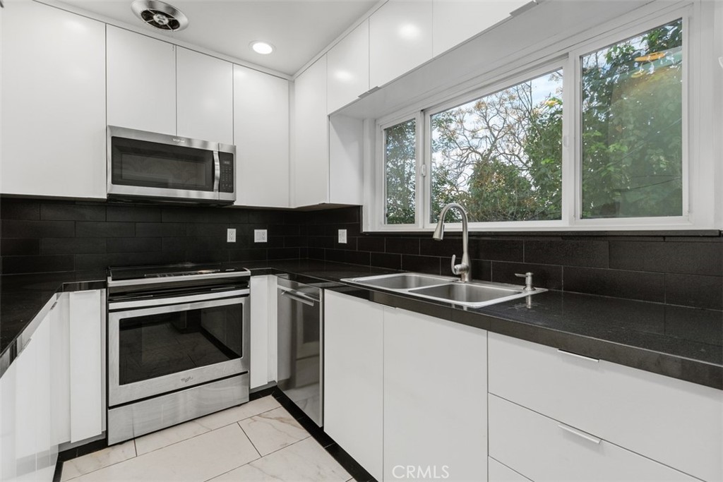 4121 Park View Terrace Riverside, CA 92501 - Photo 8 of 41 a kitchen with granite countertop a sink stove and microwave
