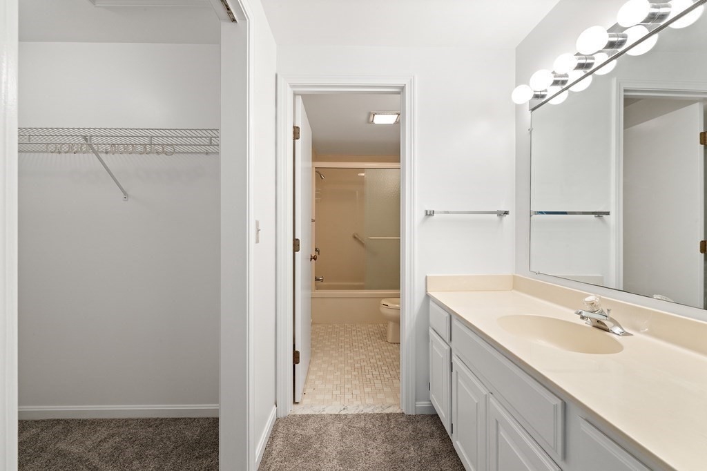 174 Lowell Road, Unit 135 Mashpee, MA 02649 - Photo 15 of 21 a bathroom with a double vanity sink mirror and shower