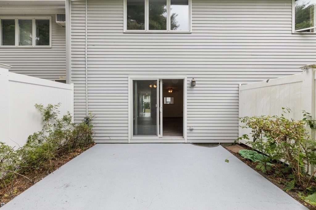 174 Lowell Road, Unit 135 Mashpee, MA 02649 - Photo 18 of 21 a view of a house and a yard