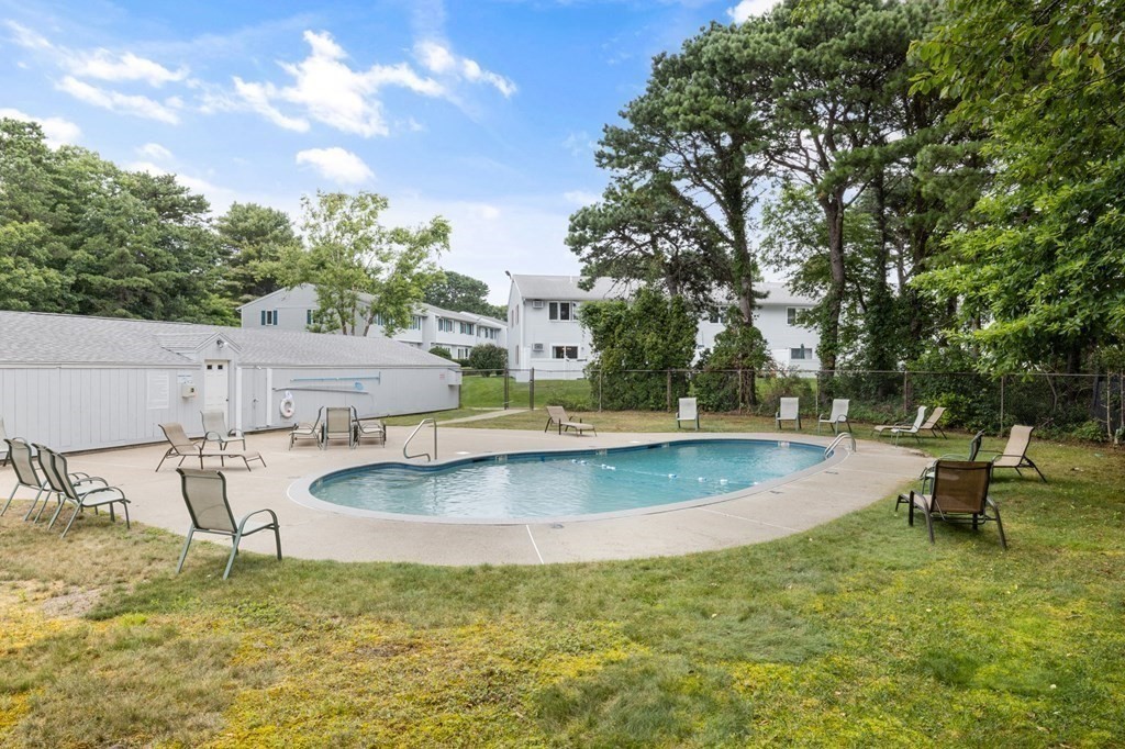 174 Lowell Road, Unit 135 Mashpee, MA 02649 - Photo 20 of 21 a view of a swimming pool with chairs