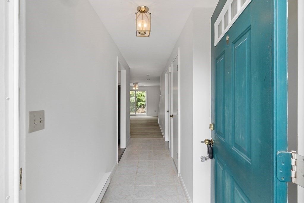 174 Lowell Road, Unit 135 Mashpee, MA 02649 - Photo 2 of 21 a view of a hallway with wooden floor
