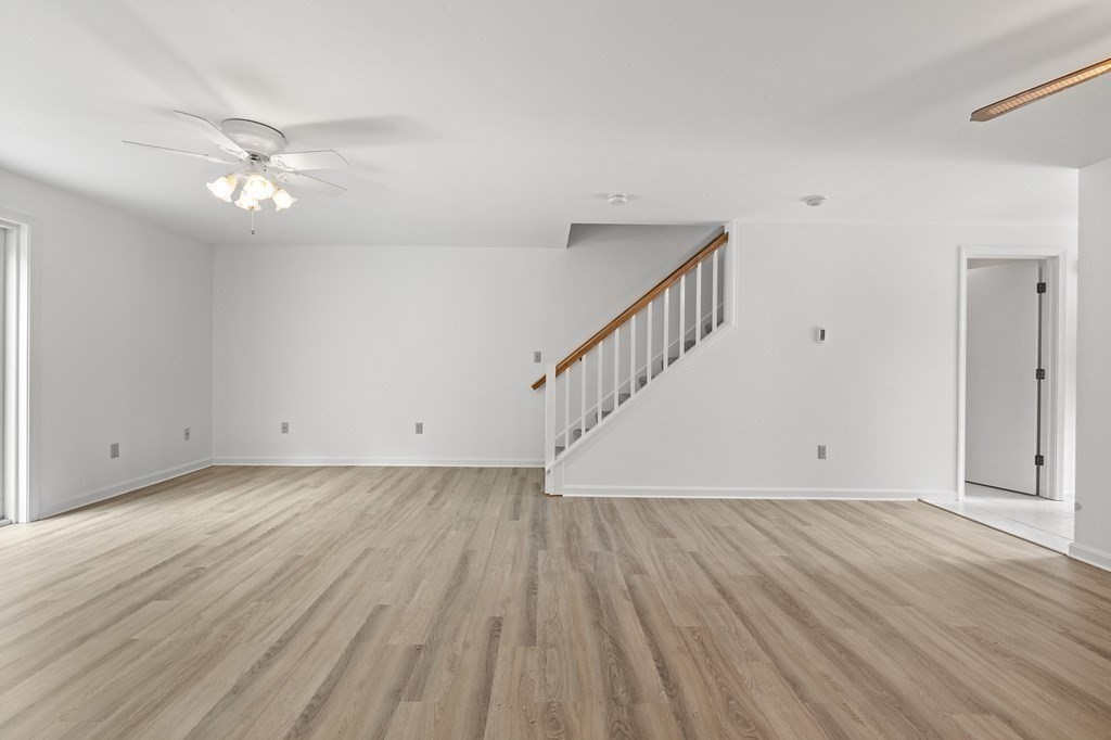 174 Lowell Road, Unit 135 Mashpee, MA 02649 - Photo 7 of 21 a view of an empty room with wooden floor