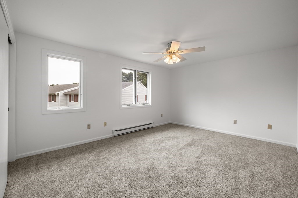 174 Lowell Road, Unit 135 Mashpee, MA 02649 - Photo 9 of 21 wooden floor in an empty room with a window
