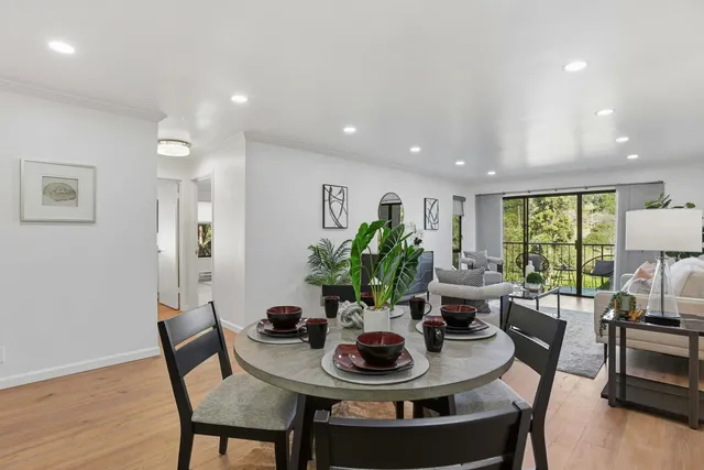 a view of a dining room with furniture window and wooden floor