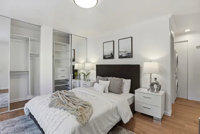 a bedroom with a bed and wooden floor