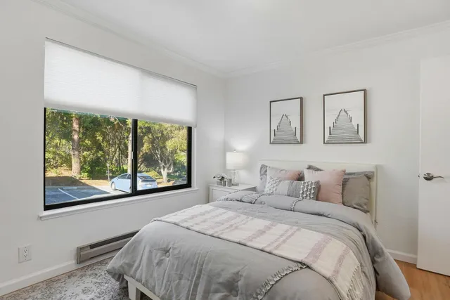 a bedroom with a large bed and a window