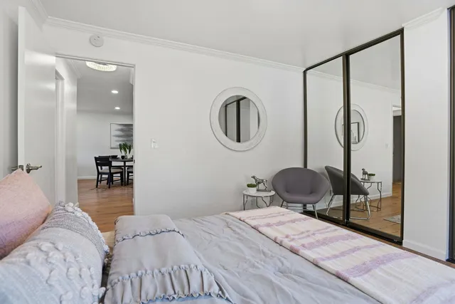 a bedroom with a bed and a mirror