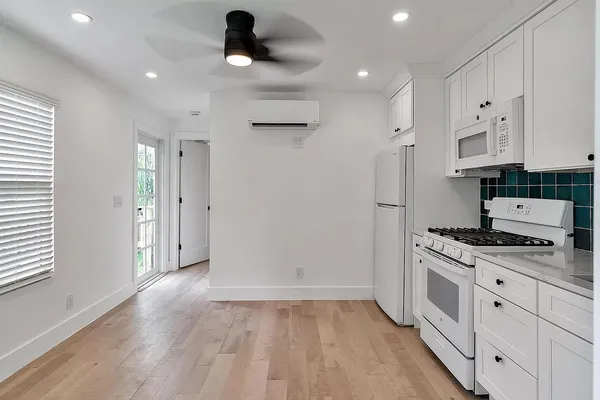 a kitchen with stainless steel appliances granite countertop a stove and a refrigerator