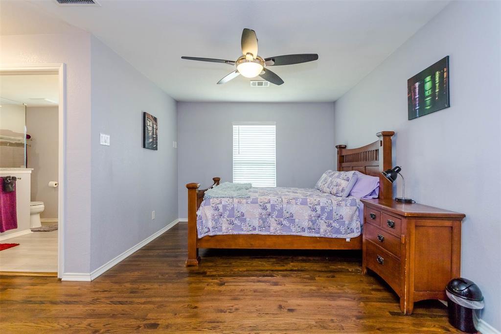 1333 South Pine Street Grapevine, TX 76051 - Photo 17 of 33 a bedroom with a bed and a chandelier