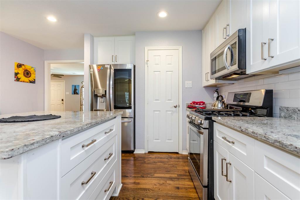 1333 South Pine Street Grapevine, TX 76051 - Photo 6 of 33 a kitchen with stainless steel appliances granite countertop a refrigerator and a stove top oven