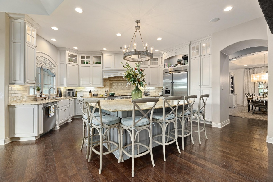 216 Vista Lane Georgetown, TX 78633 - Photo 15 of 40 a view of a dining room and livingroom with furniture wooden floor kitchen view and a chandelier
