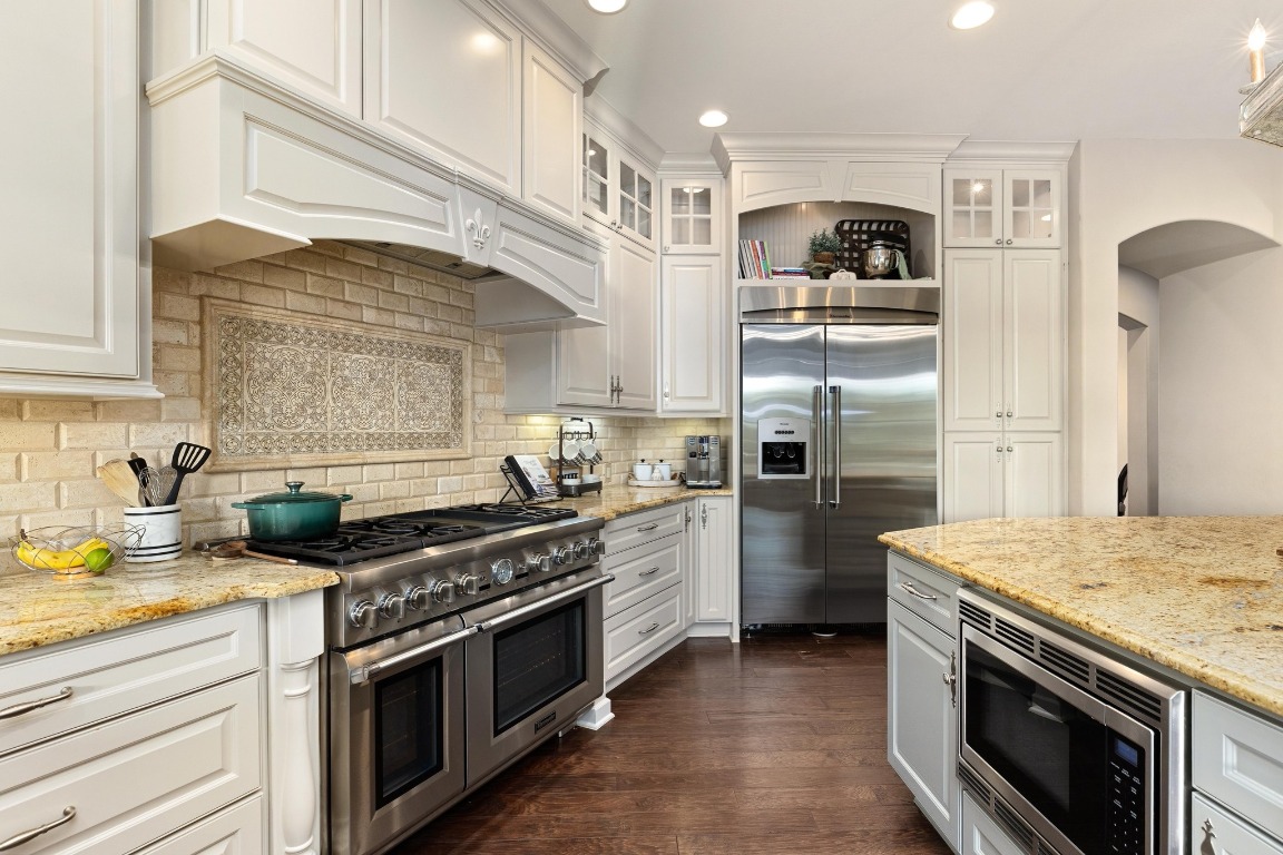 216 Vista Lane Georgetown, TX 78633 - Photo 16 of 40 a kitchen with stainless steel appliances granite countertop a stove a refrigerator and a sink
