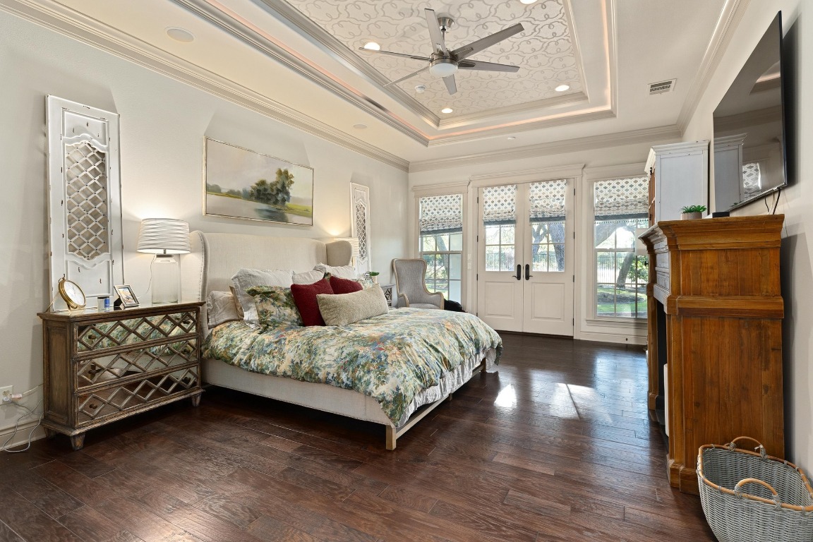 216 Vista Lane Georgetown, TX 78633 - Photo 22 of 40 a spacious bedroom with a bed a dresser and wooden floor