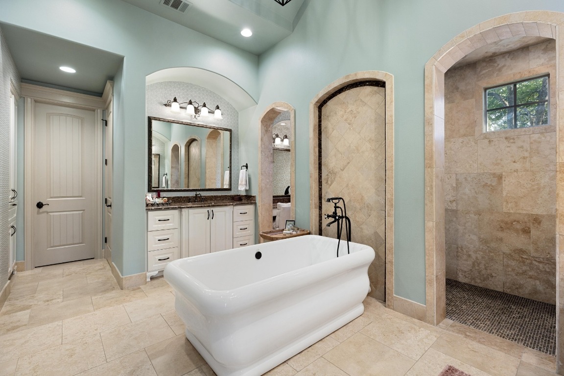 216 Vista Lane Georgetown, TX 78633 - Photo 23 of 40 a spacious bathroom with a tub sink and mirror
