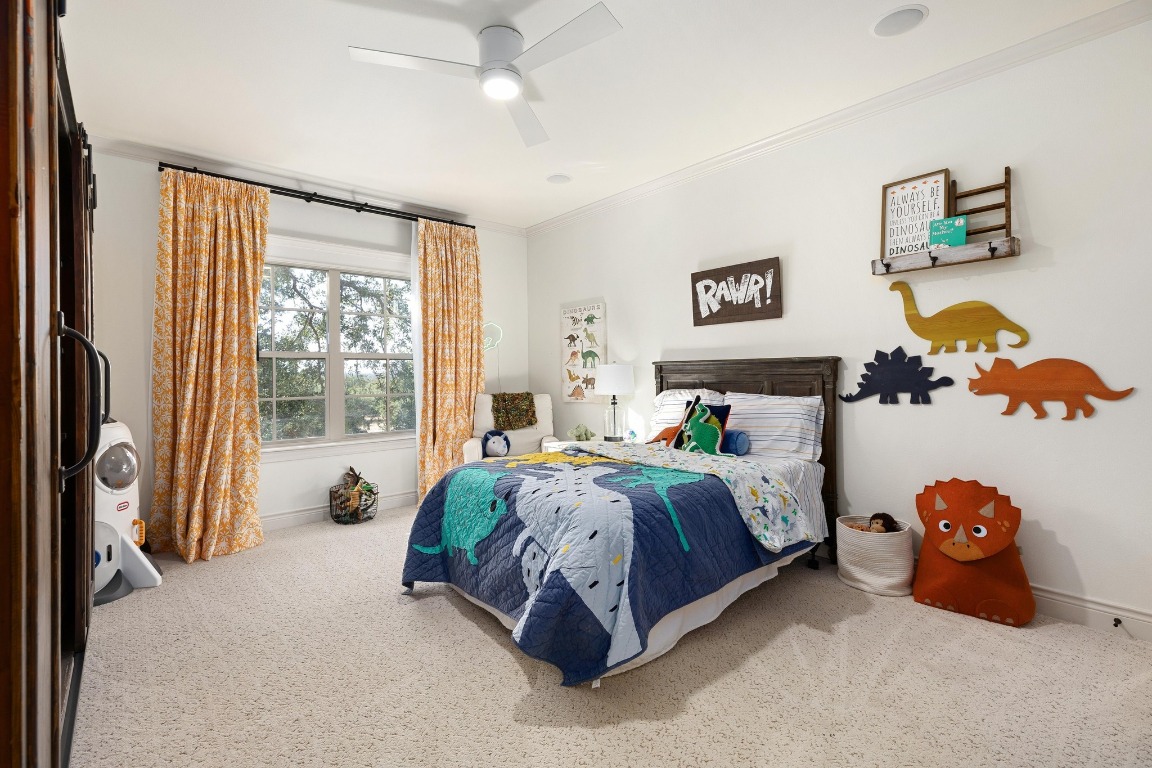 216 Vista Lane Georgetown, TX 78633 - Photo 30 of 40 a spacious bedroom with a bed and a couch