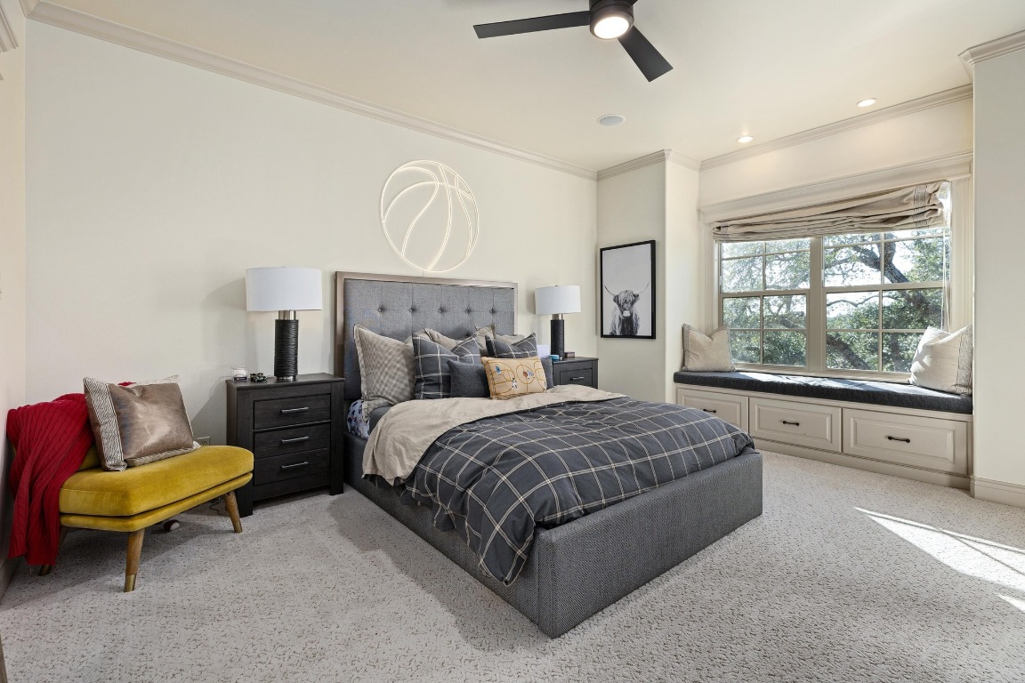 216 Vista Lane Georgetown, TX 78633 - Photo 31 of 40 a spacious bedroom with a bed a couch and a window