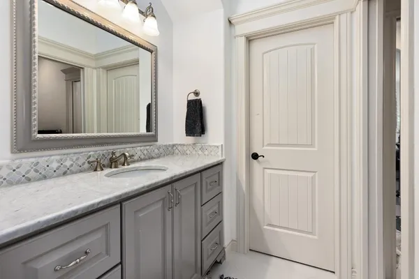 a bathroom with a sink vanity and a mirror