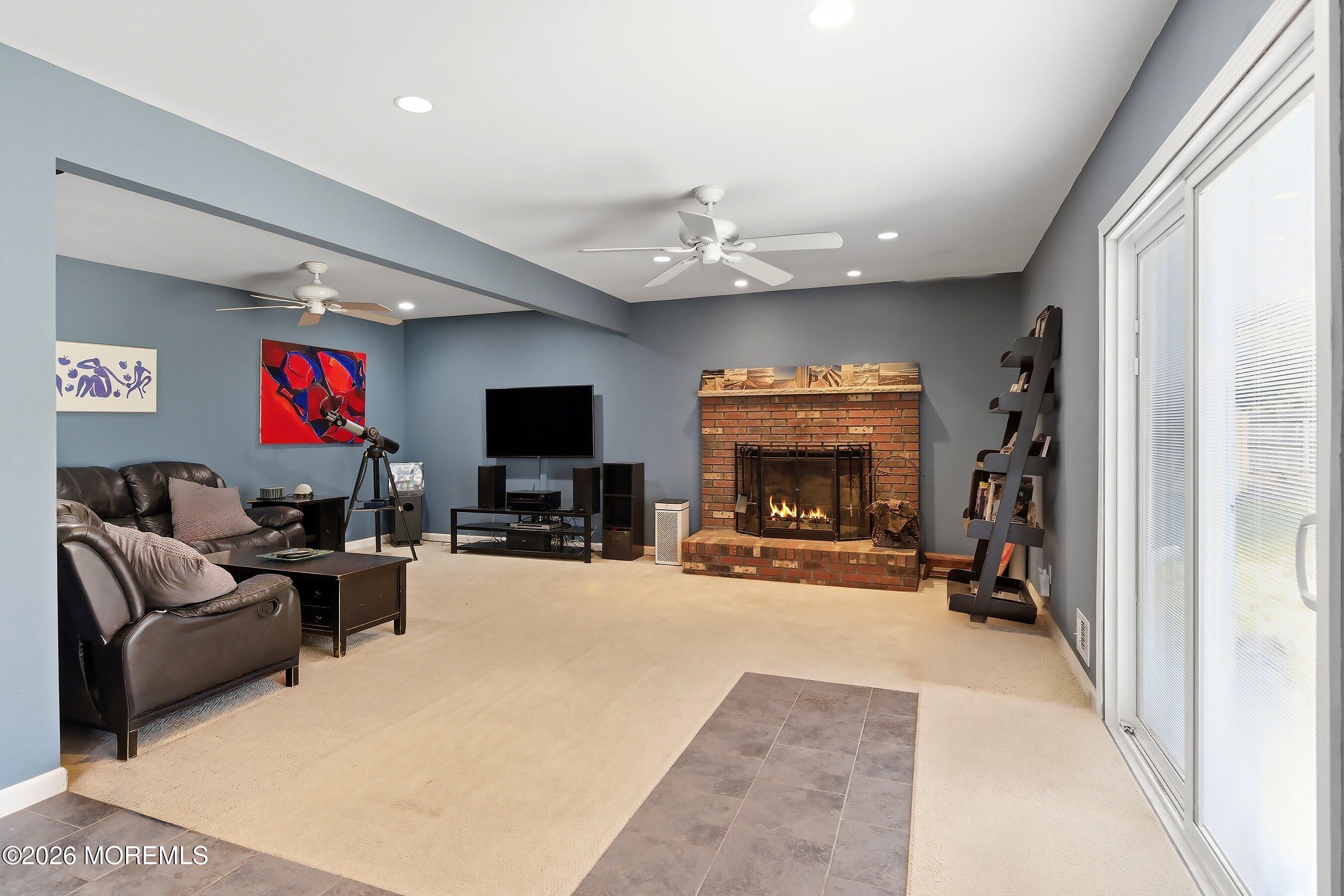 822 York Road Brick, NJ 08724 - Photo 12 of 37 a living room with furniture a fireplace and a flat screen tv