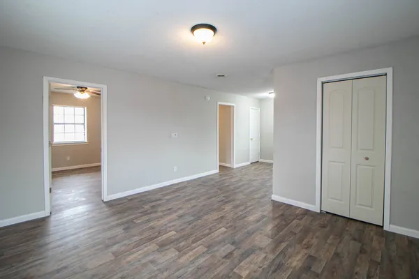wooden floor in an empty room with a window