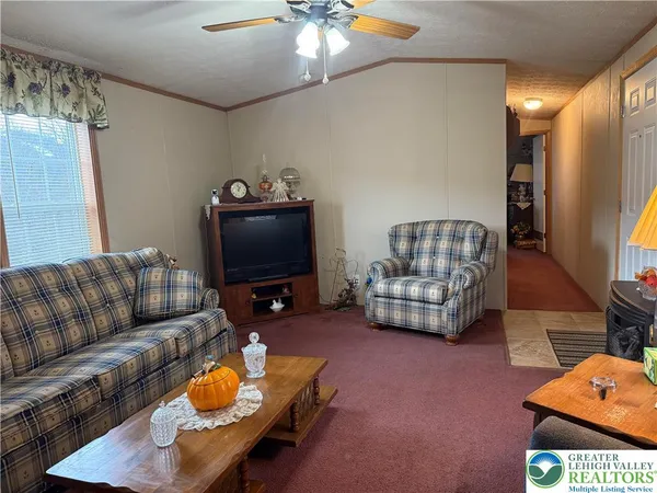 a living room with furniture and a flat screen tv