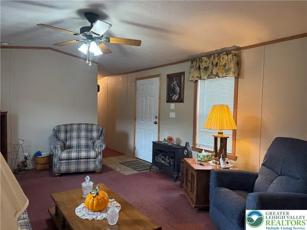 a living room with furniture and a lamp