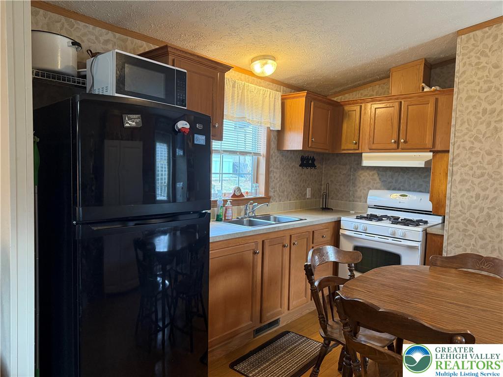 15 Chestnut Ridge Circle Kunkletown, PA 18058 - Photo 14 of 31 a kitchen with stainless steel appliances granite countertop a refrigerator and a stove top oven