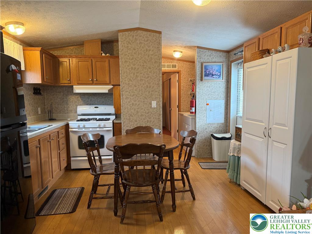 15 Chestnut Ridge Circle Kunkletown, PA 18058 - Photo 16 of 31 a kitchen with stainless steel appliances a stove a refrigerator a table and chairs