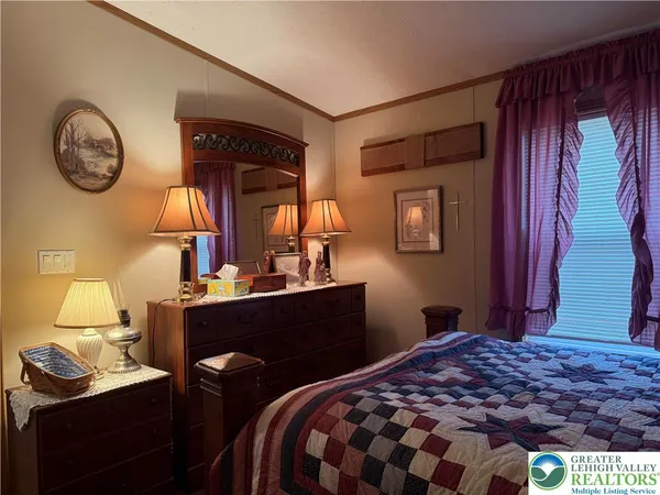 a bedroom with a bed and a table with a mirror