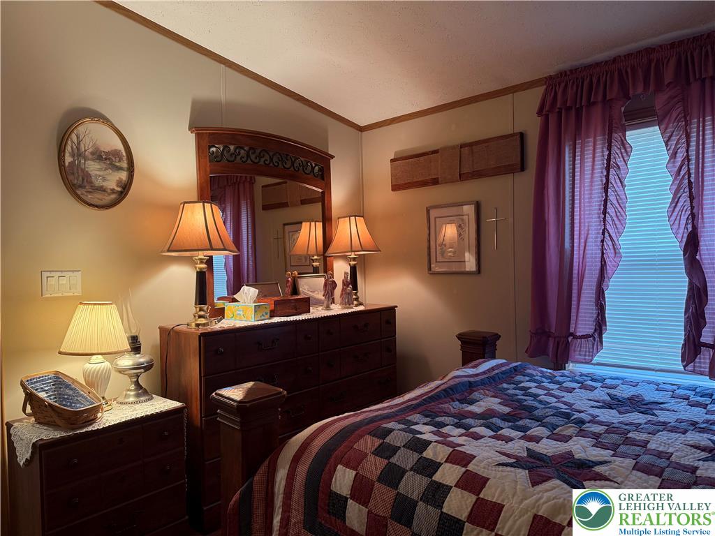 15 Chestnut Ridge Circle Kunkletown, PA 18058 - Photo 24 of 31 a bedroom with a bed and a table with a mirror