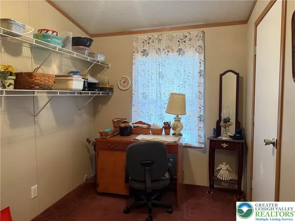 a room with a refrigerator and a wooden floor