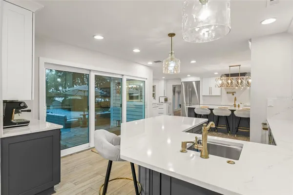 a living room with furniture chandelier and a large window