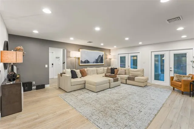 a living room with furniture tv and wooden floor