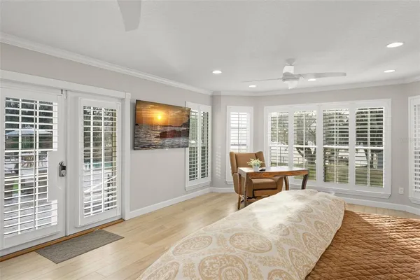 a hallway with couches and a dining table with wooden floor