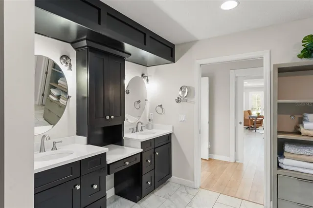 a view of a kitchen with wooden floor and electronic appliances