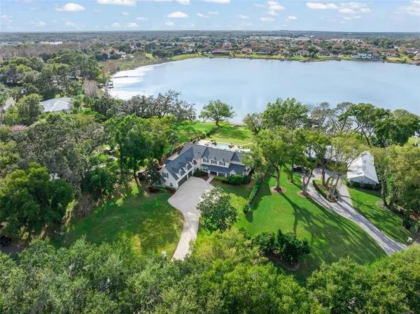 a backyard of a house with a yard and outdoor seating